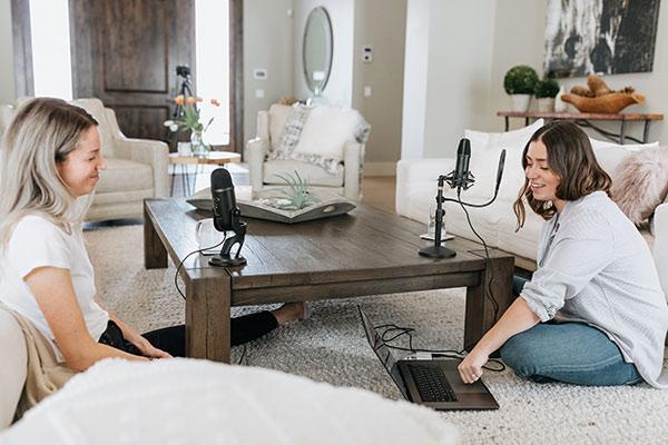 Chicas charlando y grabando su podcast en el salón de su casa