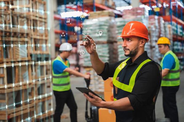 operario en almacén utilizando una aplicación informática para gestión comercial