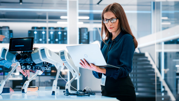 Científica con un portátil trabajando en un laboratorio de robótica